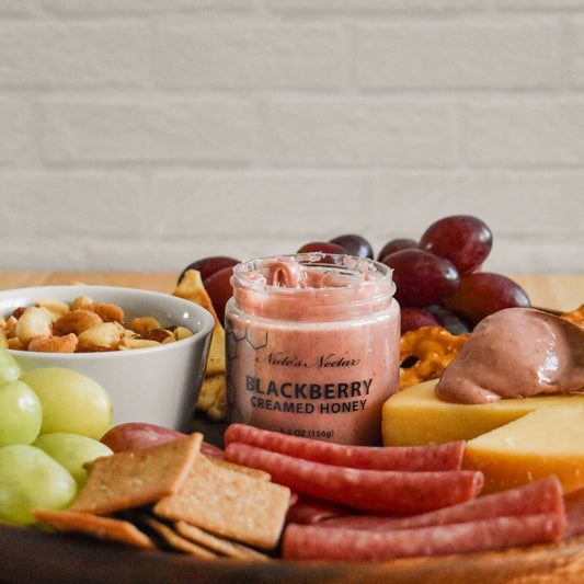 Blackberry creamed honey on charcuterie board
