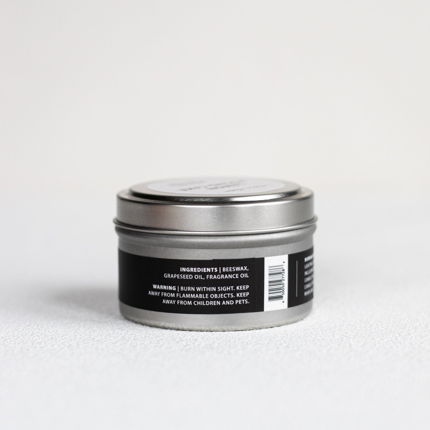 Silver tin with a black label on a white background