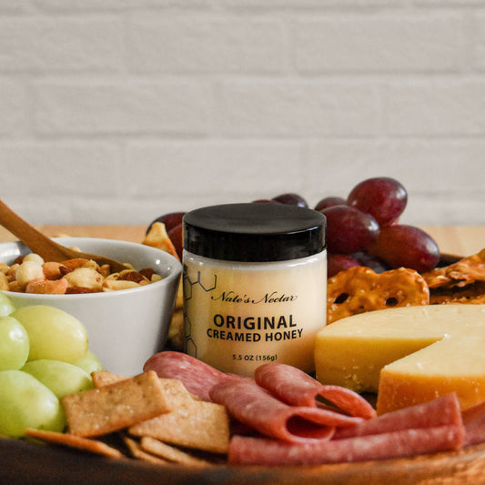 Nate's Nectar Original Creamed Honey on a charcuterie board