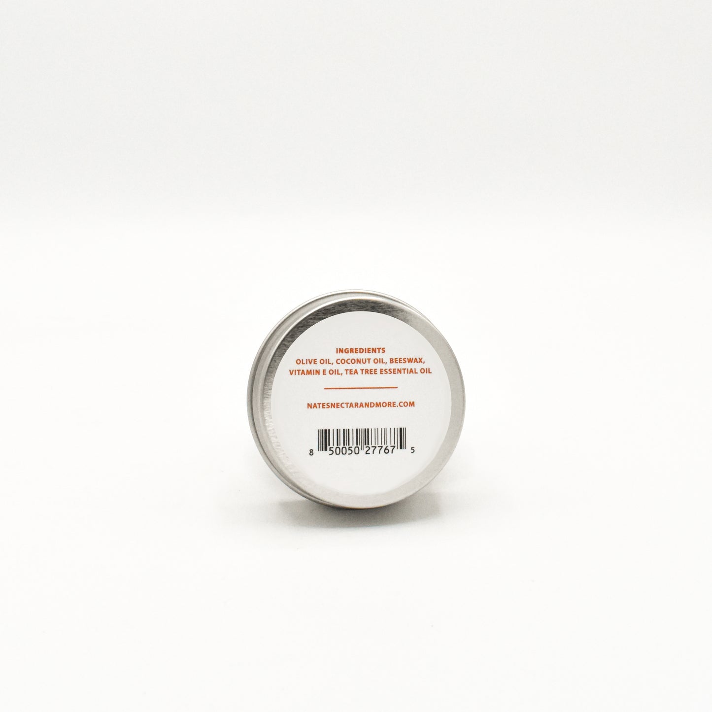 Small round container with a metal lid on a white background