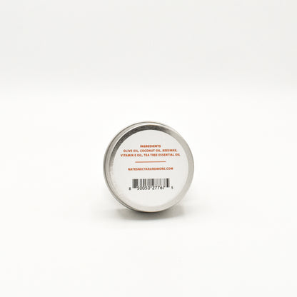 Small round container with a metal lid on a white background