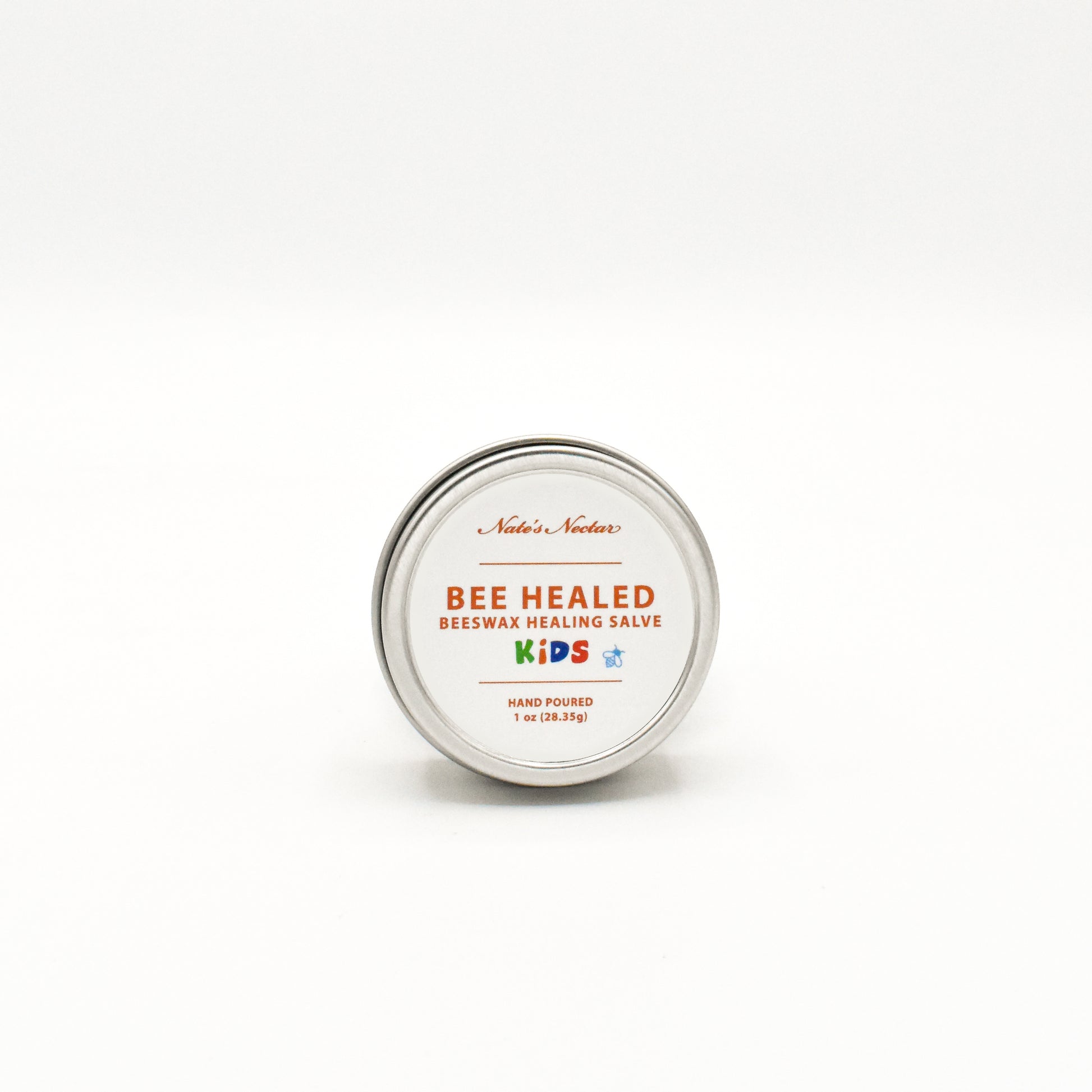 Bee Healed Kids beeswax healing salve tin on a white background
