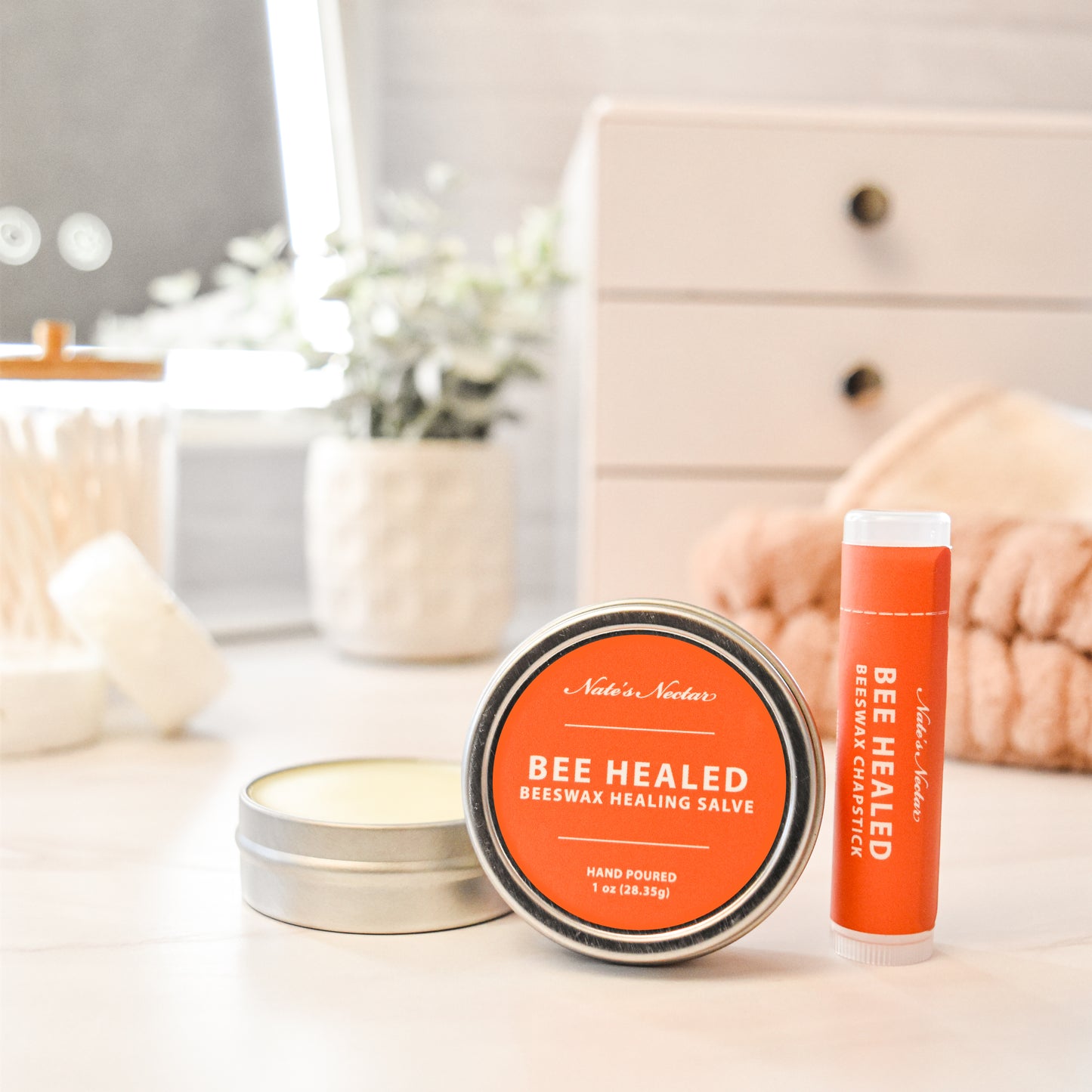 Bee Healed beeswax healing salve packaging on a table with a blurred background