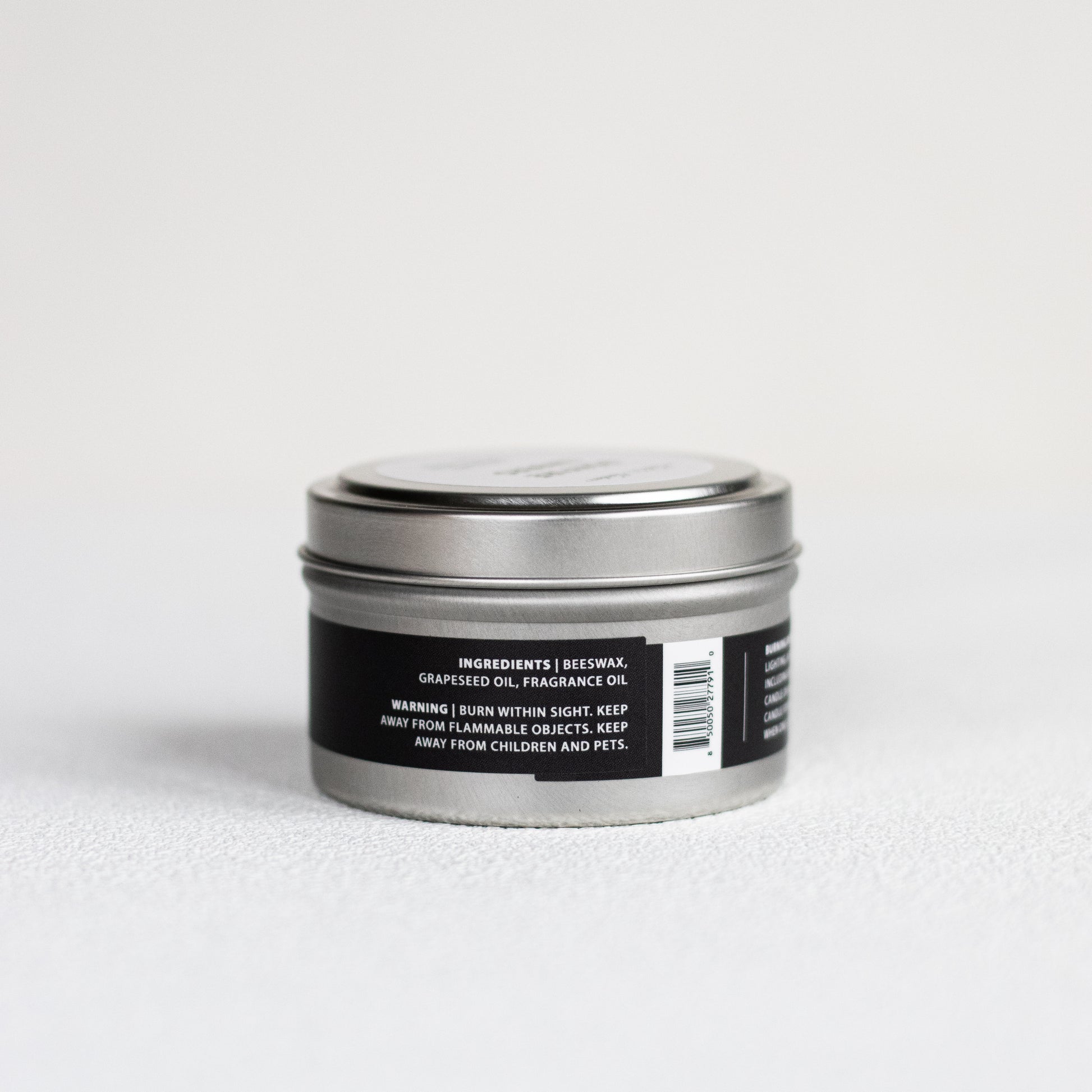 Silver tin with black label on a white background