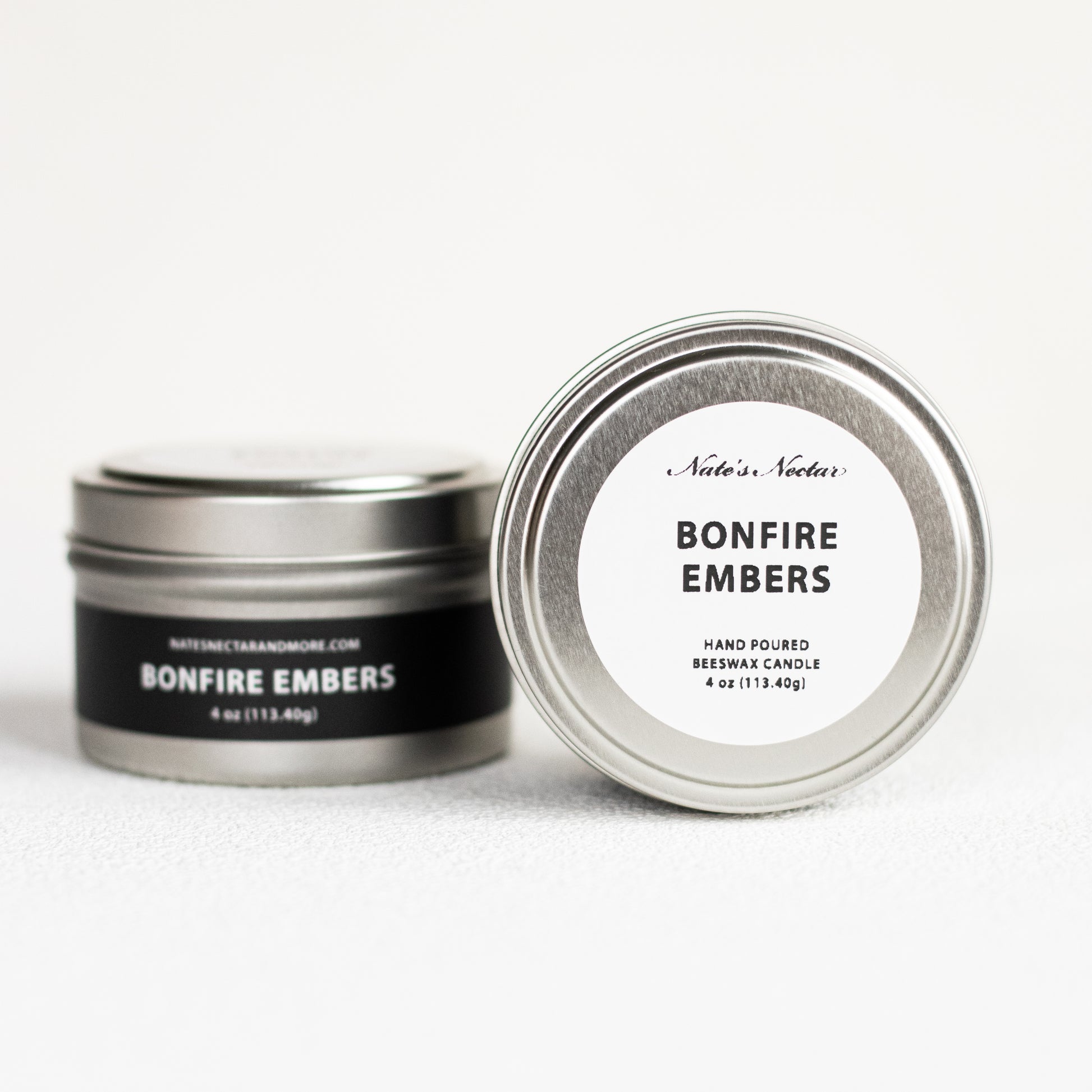 Nate's Nectar Bonfire Embers candle in a metal tin on a white background