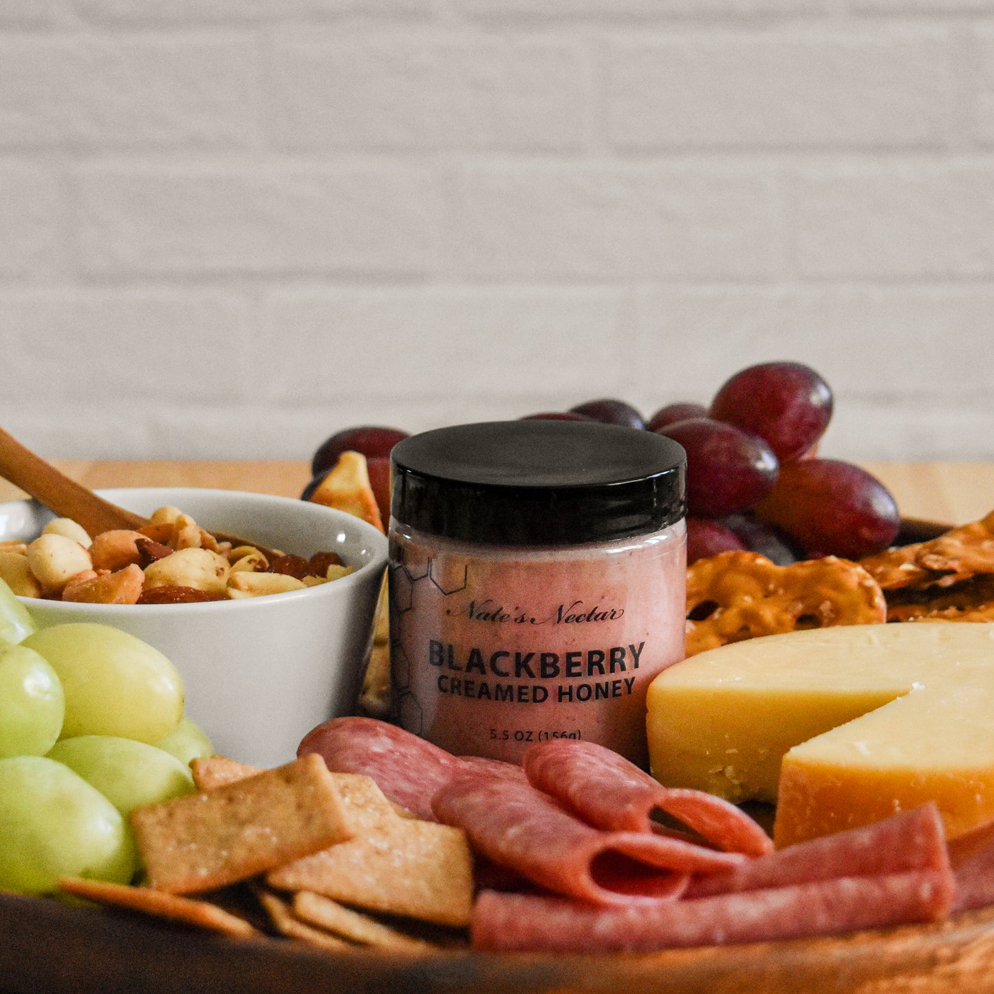 Blackberry creamed honey on charcuterie board