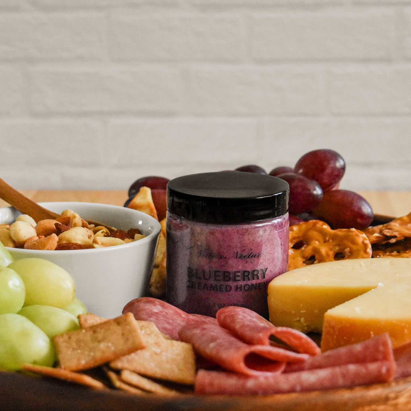 blueberry creamed honey on charcuterie board
