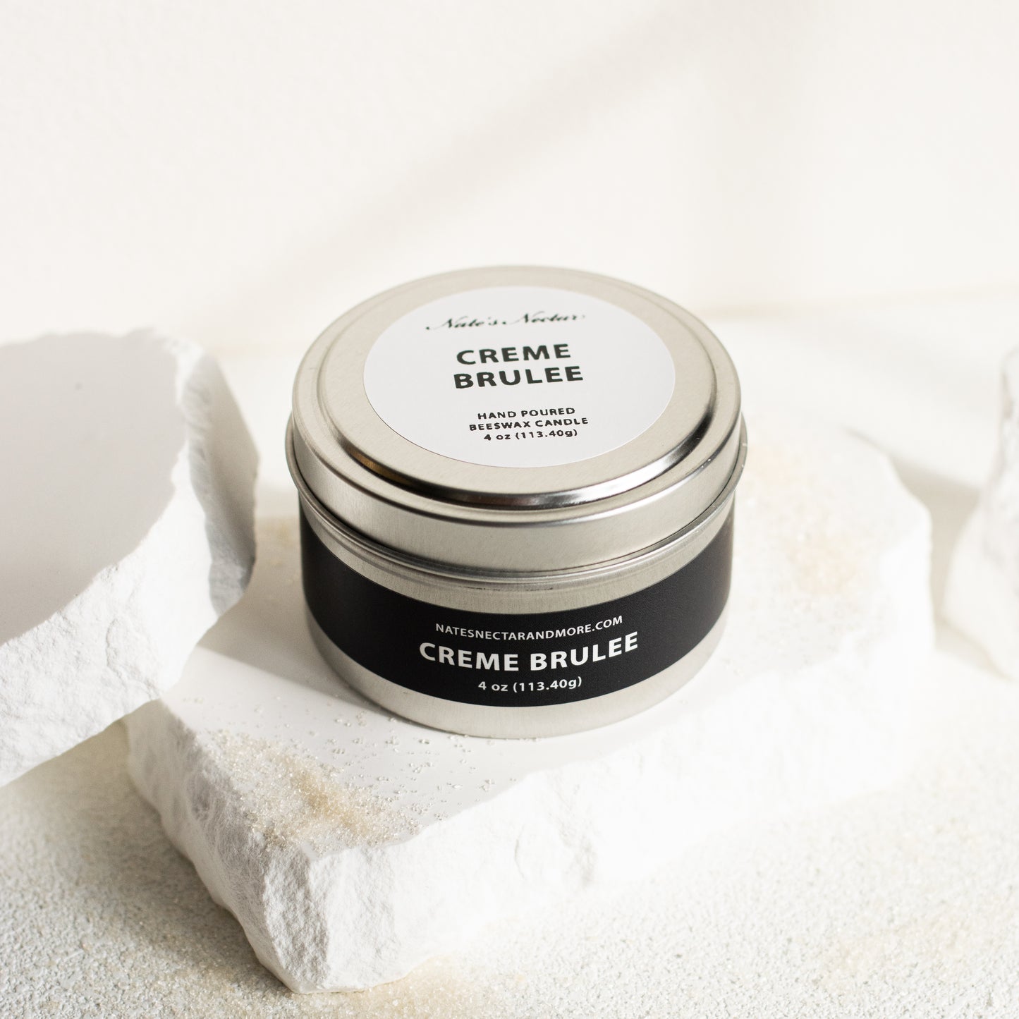 Jar of 'Creme Brèleé' on a textured white surface
