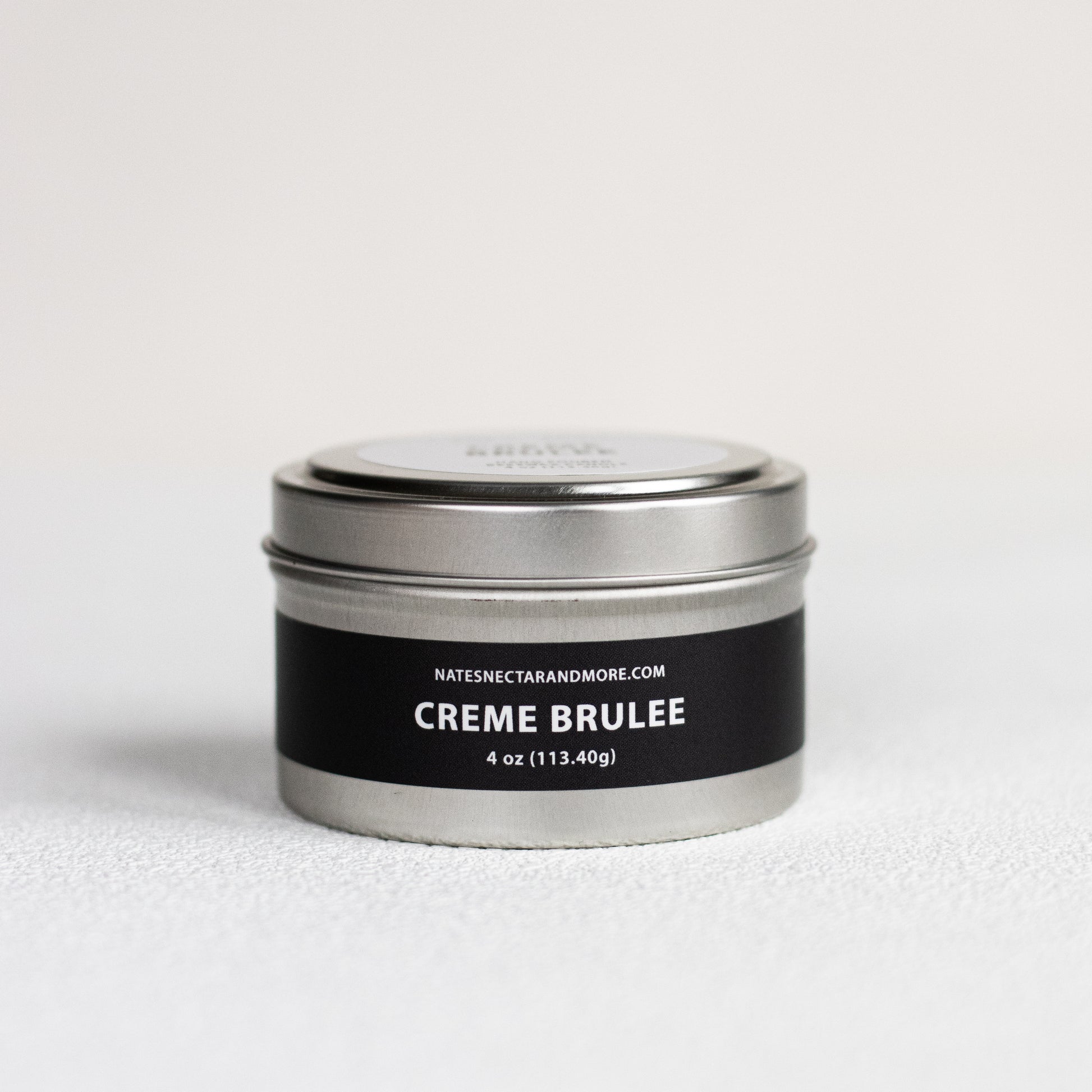 Silver tin labeled 'Creme Brulee' with a black label on a white background