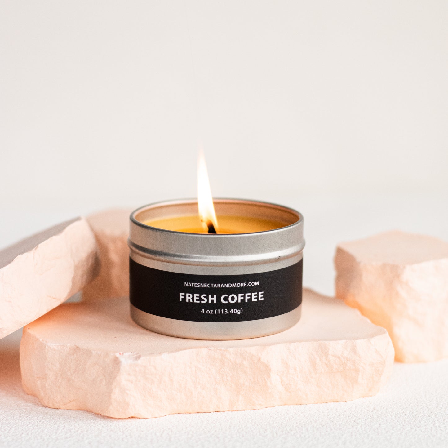 Candle labeled 'Fresh Coffee' on a light background