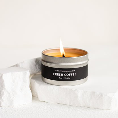 Candle in a metal container labeled 'Fresh Coffee' on a white background