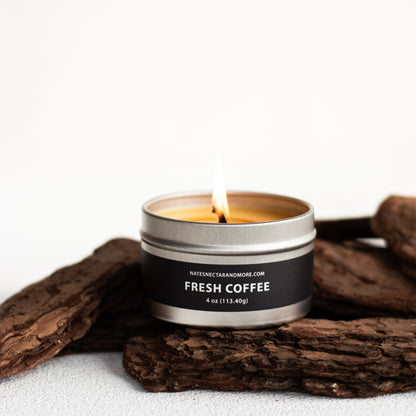 Candle in a tin labeled 'Fresh Coffee' on a white background with wooden elements.