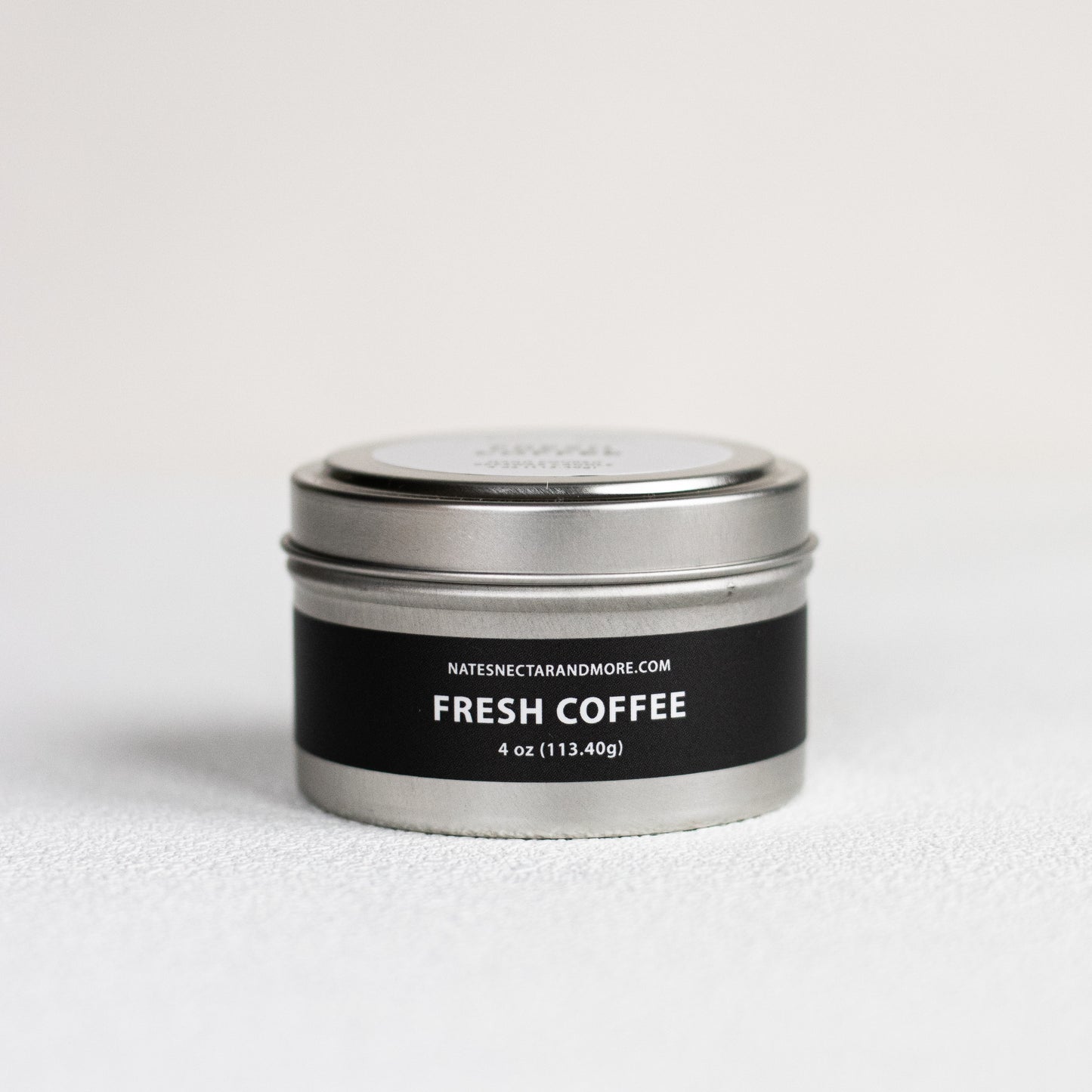 Metal tin labeled 'Fresh Coffee' on a light gray background