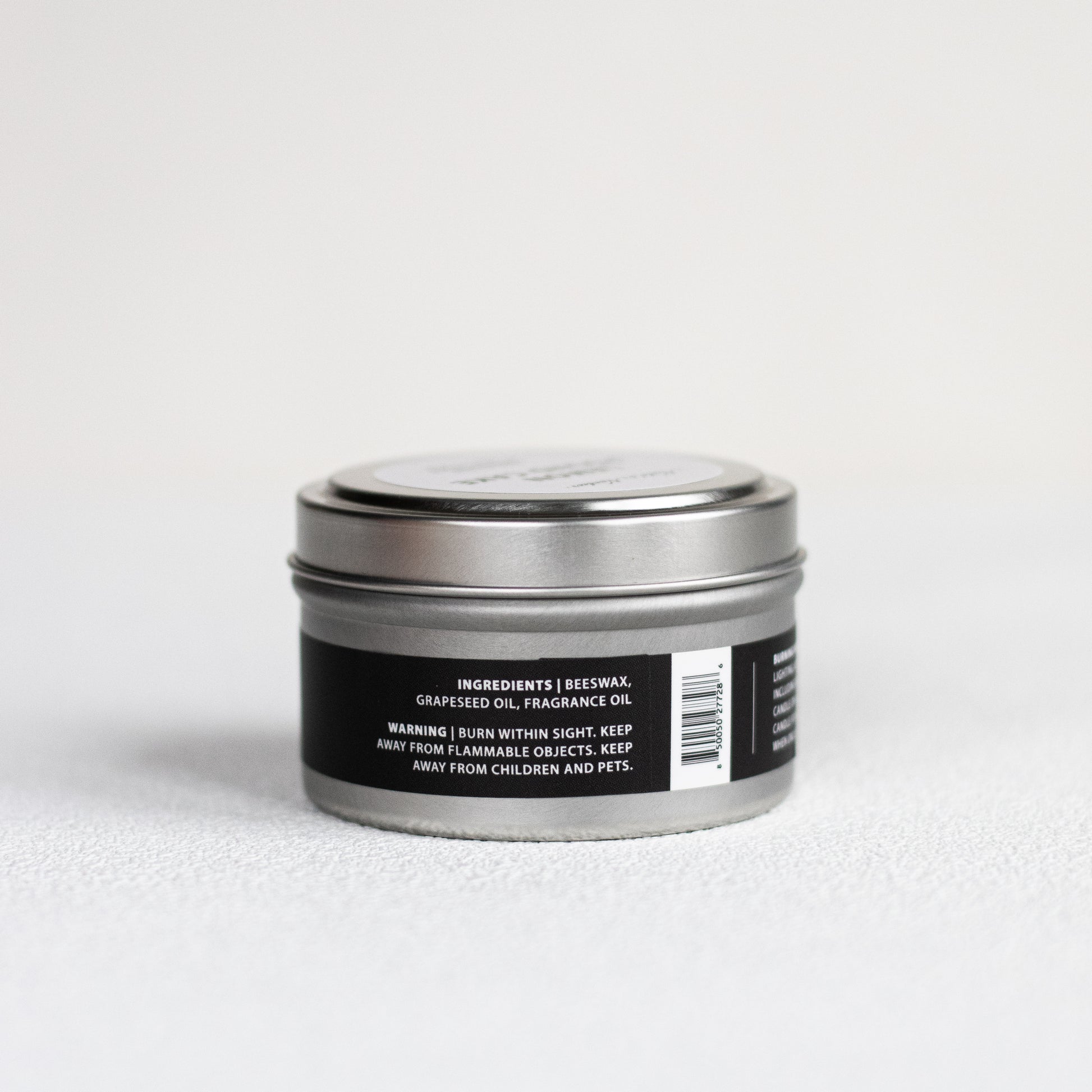 Silver tin with a black label on a white background