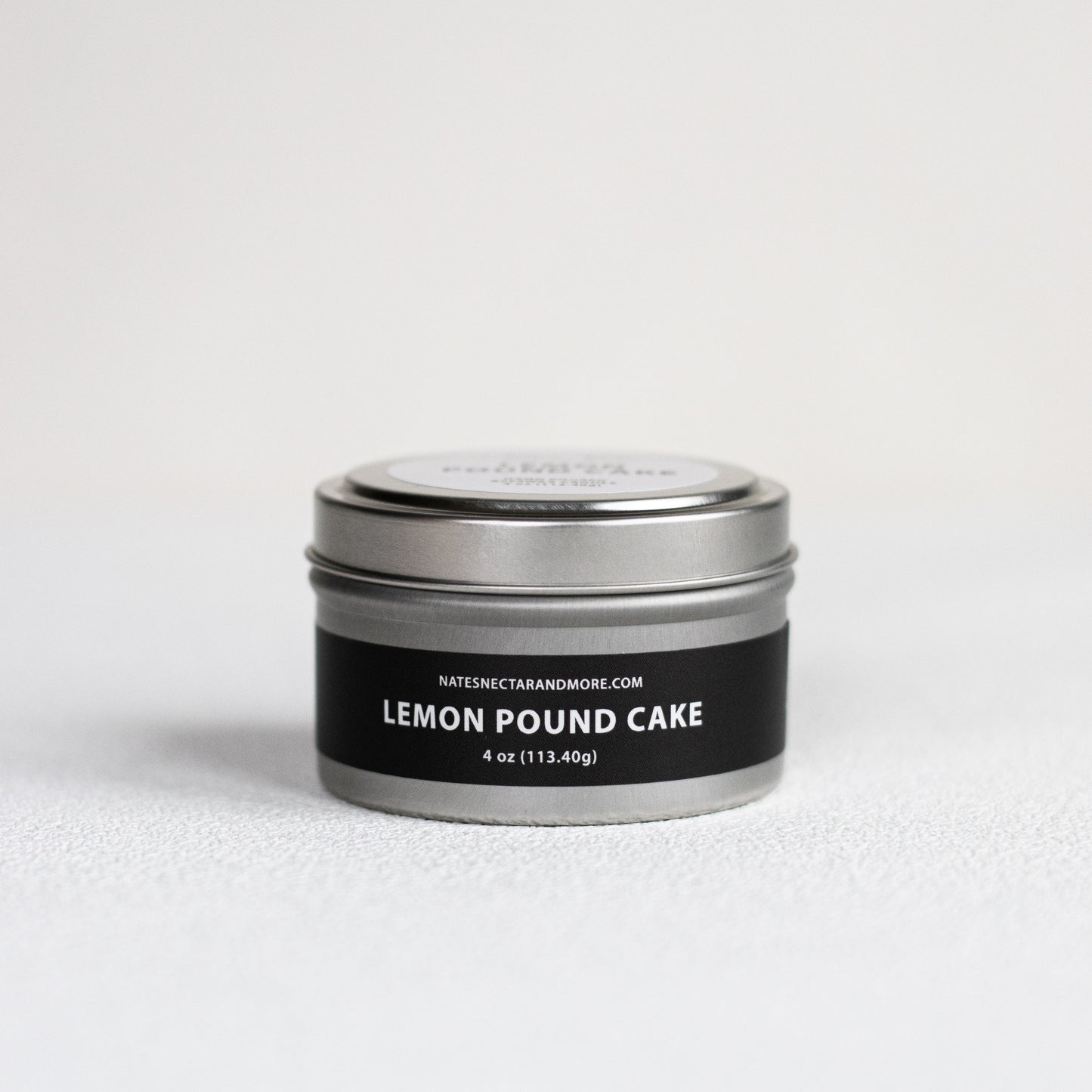 Silver tin with 'Lemon Pound Cake' label on a white background