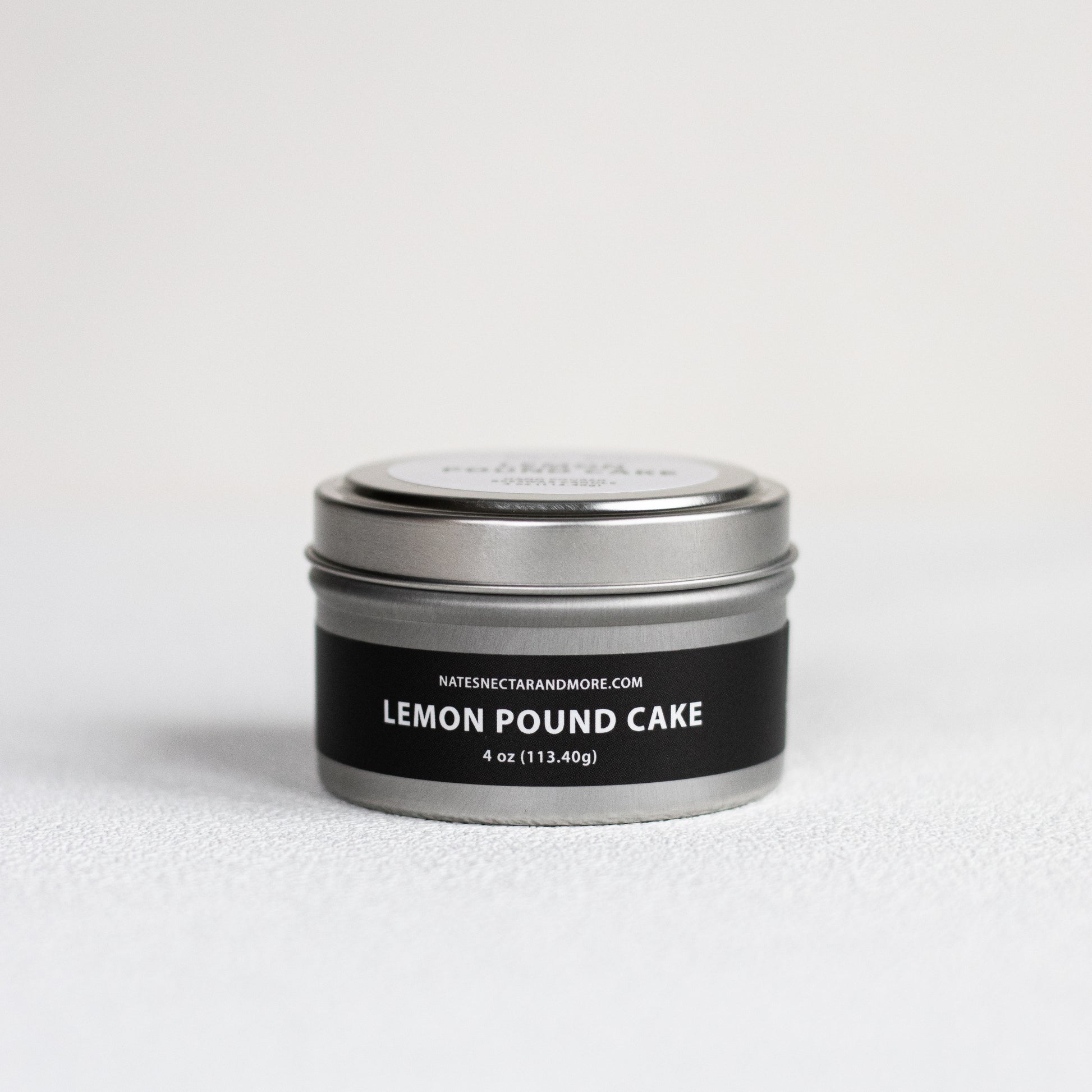 Silver tin with 'Lemon Pound Cake' label on a white background