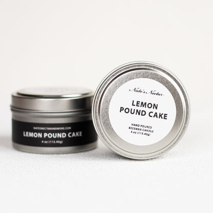 Two tins of 'Lemon Pound Cake' candle with labels on a white background
