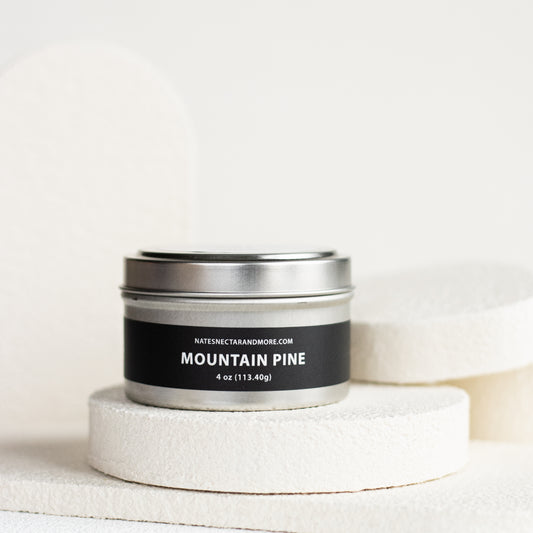 Candle tin labeled 'Mountain Pine' on a white background