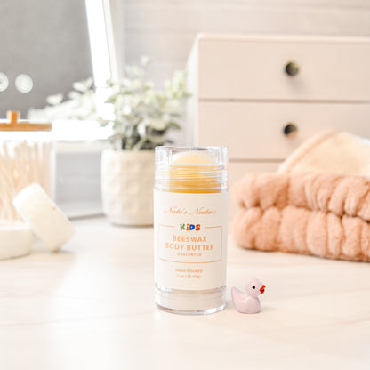 Beeswax body butter for kids on a bathroom counter with a neutral background