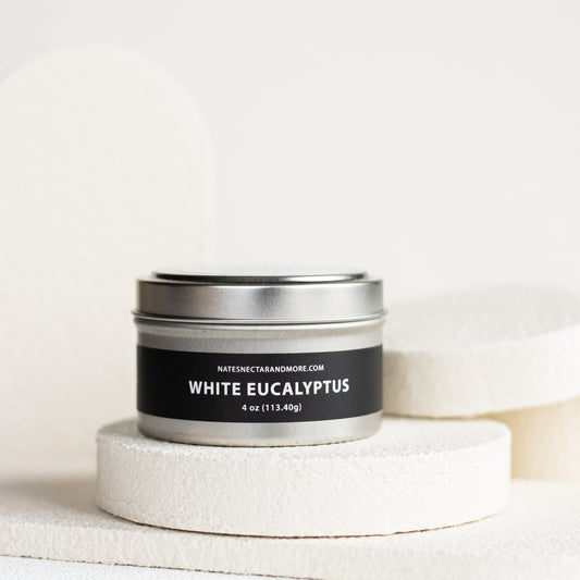 Candle tin labeled 'White Eucalyptus' on a white background