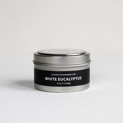 Candle tin labeled 'White Eucalyptus' on a light gray background