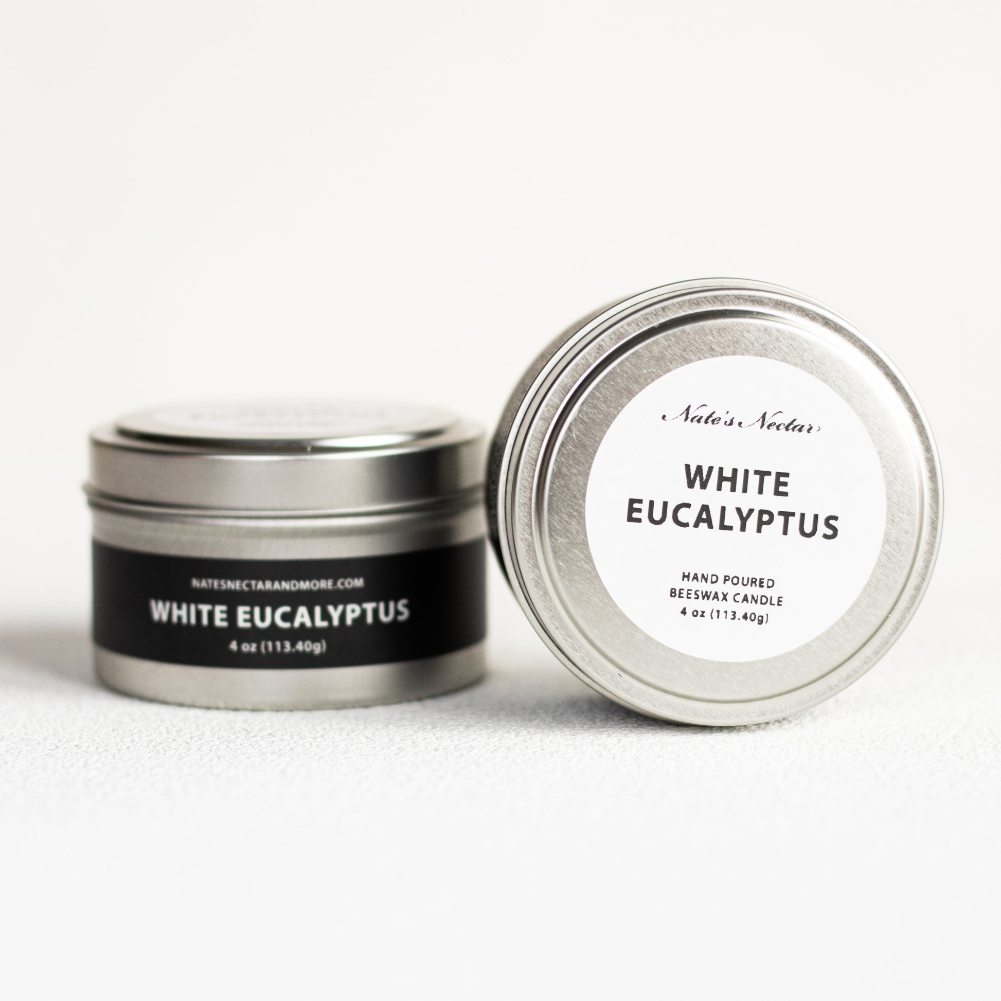 Two metal tins labeled 'White Eucalyptus' on a white background